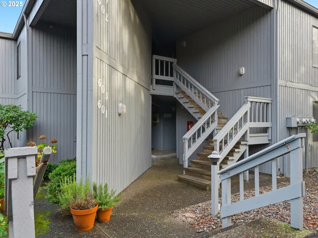 a view of house with potted plants on stairs
