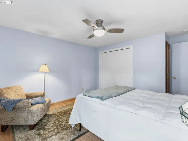 a bathroom with a granite countertop toilet sink and mirror