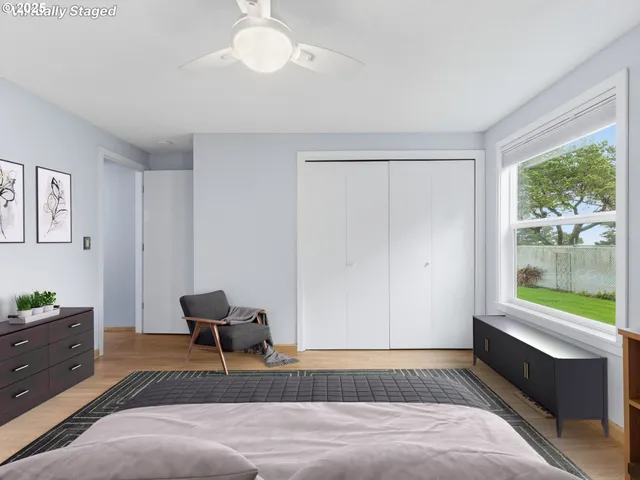 a bedroom with a bed and a window with rug