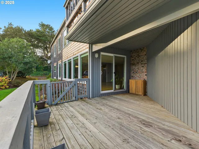 a view of backyard with deck and outdoor seating