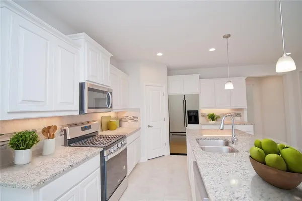 a kitchen with kitchen island cabinets and a sink