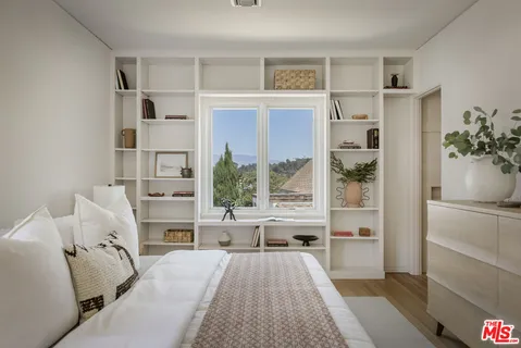 a bedroom with a bed and a lamp