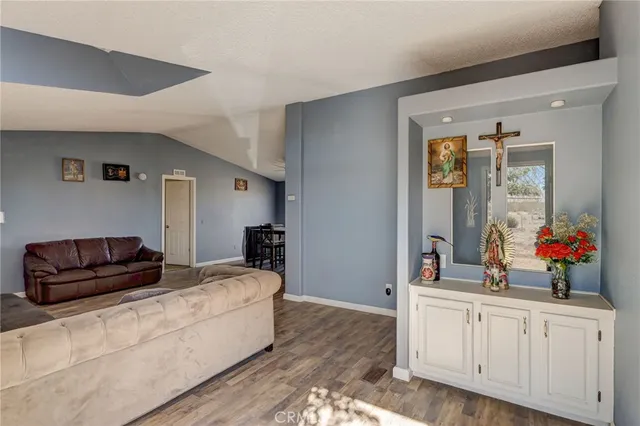 a living room with furniture and a mirror