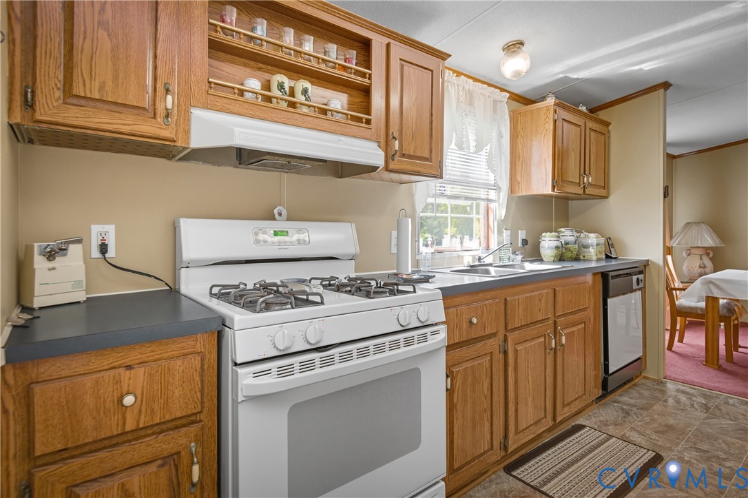 23344 Booth Road Stony Creek, VA 23882 - Photo 17 of 45 a kitchen with stainless steel appliances granite countertop a stove a sink and a refrigerator