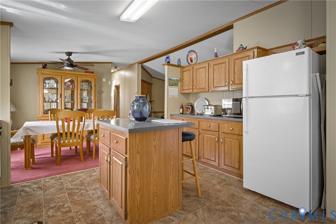 23344 Booth Road Stony Creek, VA 23882 - Photo 18 of 45 a kitchen with sink refrigerator and cabinets