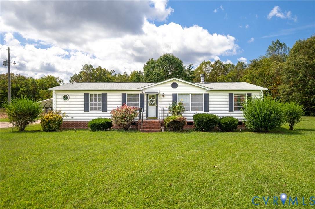 23344 Booth Road Stony Creek, VA 23882 - Photo 2 of 45 a view of a house next to a big yard and large trees
