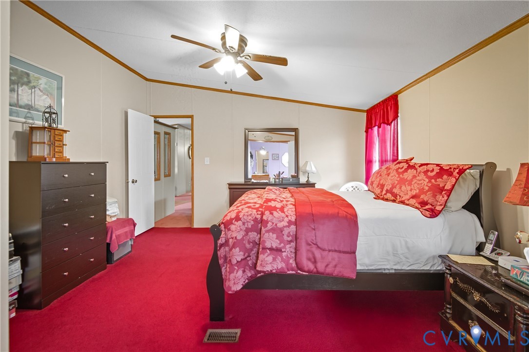 23344 Booth Road Stony Creek, VA 23882 - Photo 27 of 45 a bedroom with a bed and a mirror