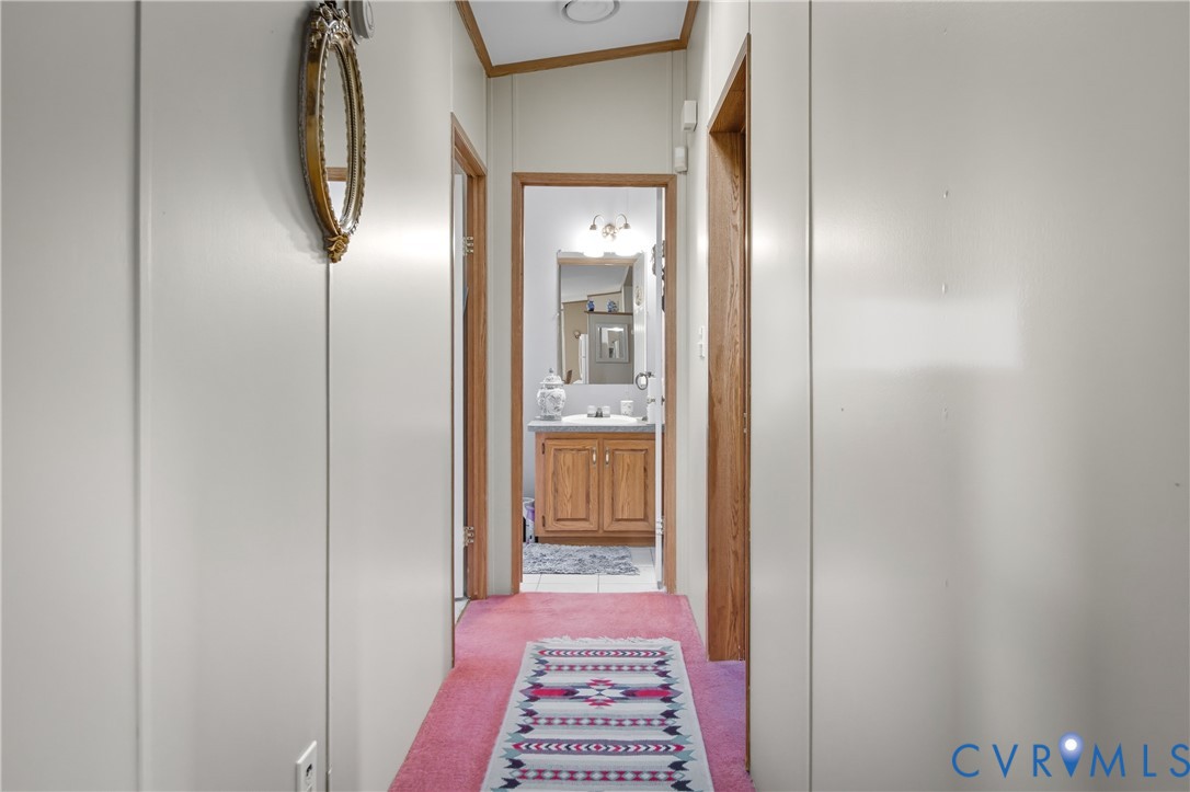 23344 Booth Road Stony Creek, VA 23882 - Photo 31 of 45 a view of a hallway with a bathroom and a mirror