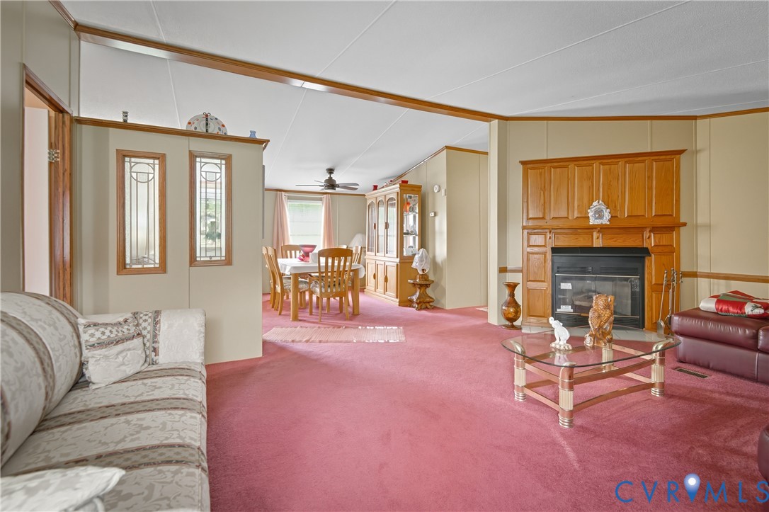 23344 Booth Road Stony Creek, VA 23882 - Photo 4 of 45 a living room with furniture a fireplace and a flat screen tv