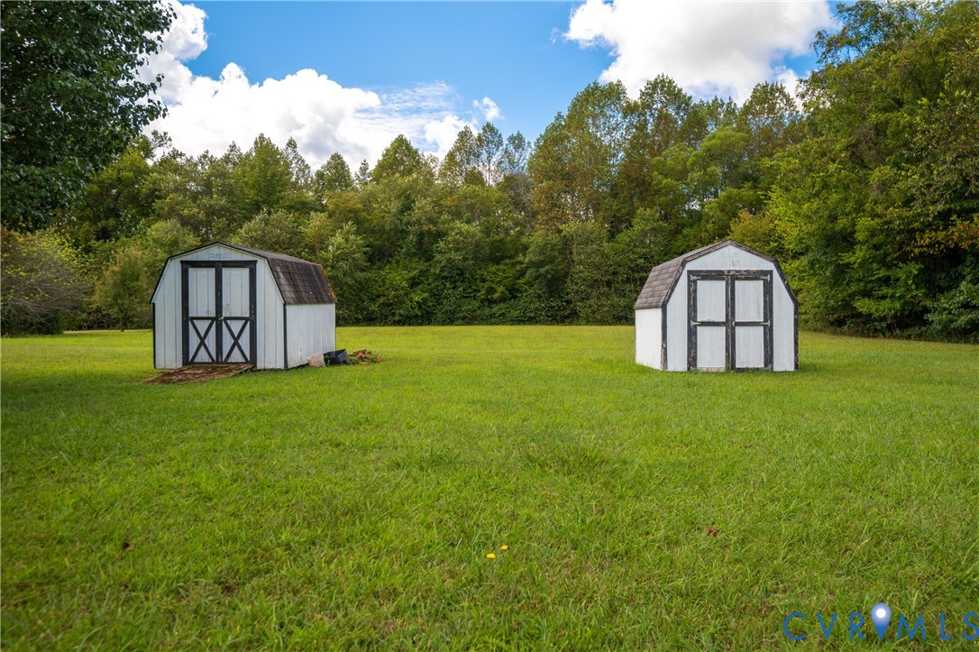 23344 Booth Road Stony Creek, VA 23882 - Photo 43 of 45 a wooden bench sitting in the middle of a field