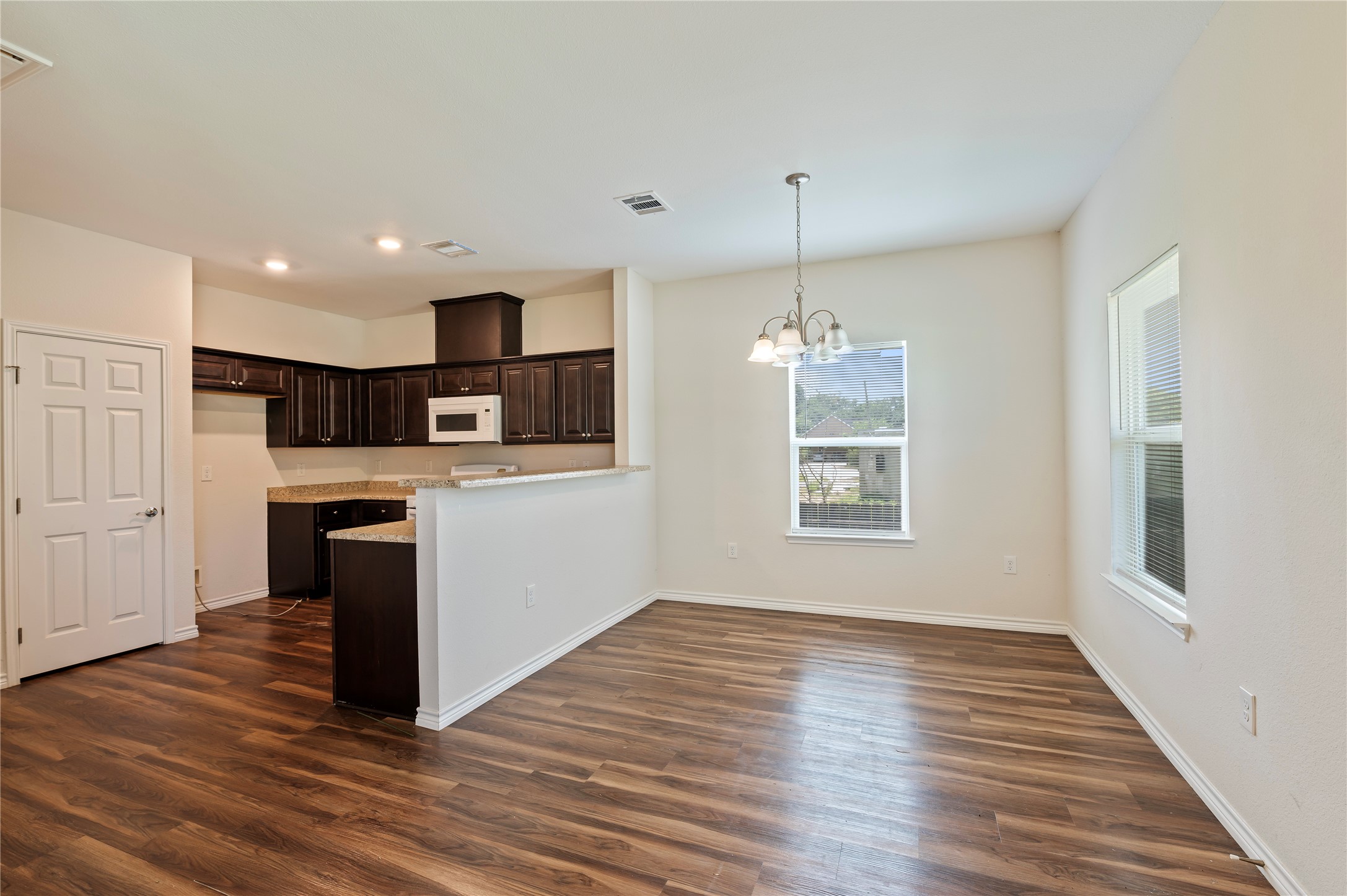 1125 Lake Road La Marque, TX 77568 - Photo 8 of 33 a kitchen with stainless steel appliances granite countertop a refrigerator oven a sink dishwasher and white cabinets with wooden floor