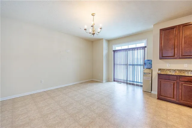wooden floor in an empty room with a kitchen