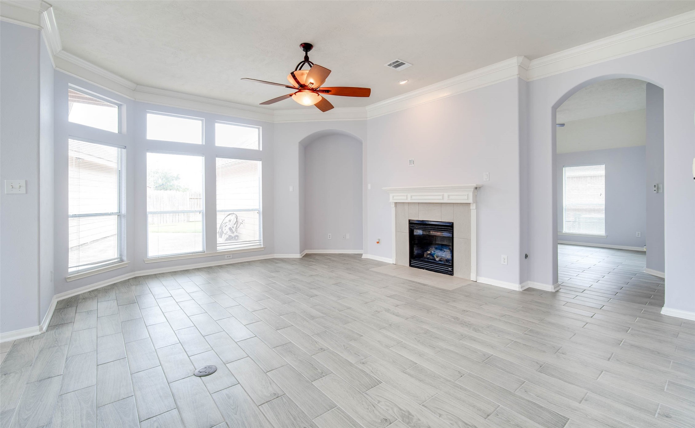 9323 Hillhaven Court Rosenberg, TX 77469 - Photo 21 of 37 a view of an empty room with wooden floor fireplace and a window