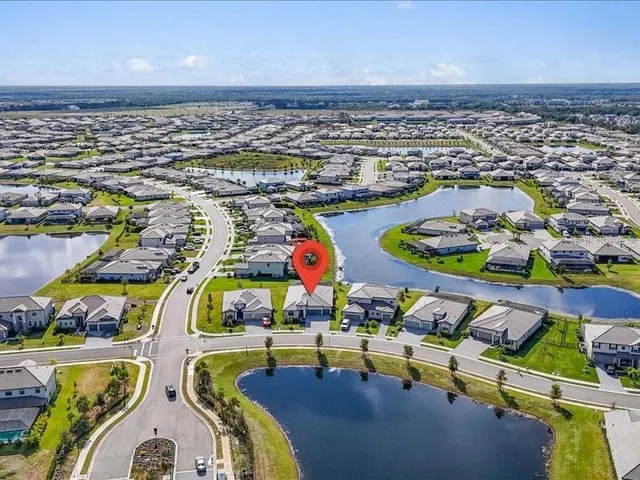 a view of swimming pool with a lawn chairs