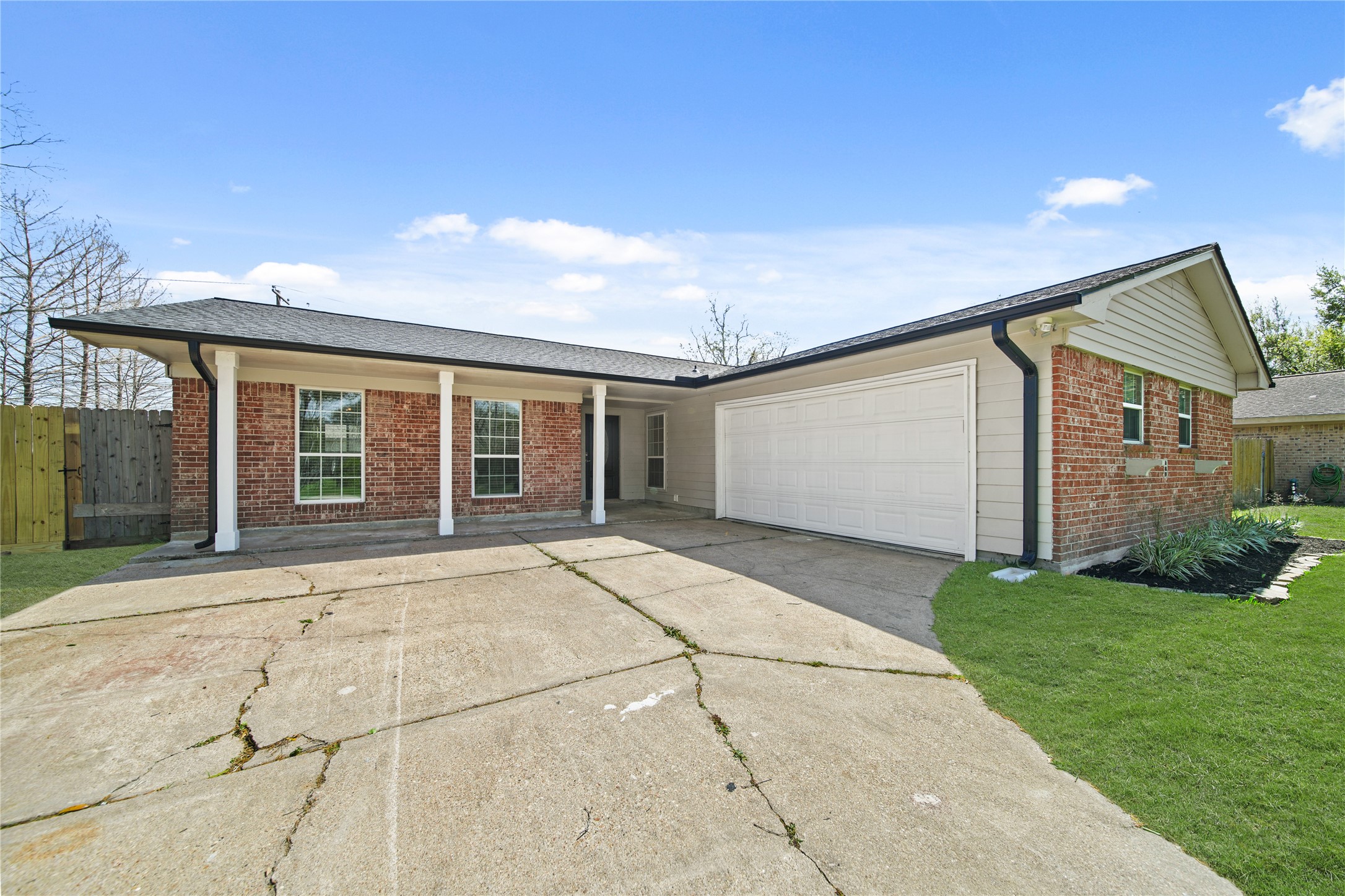 303 Rachael Lane Friendswood, TX 77546 - Photo 2 of 15 Double wide driveway with a two car garage.