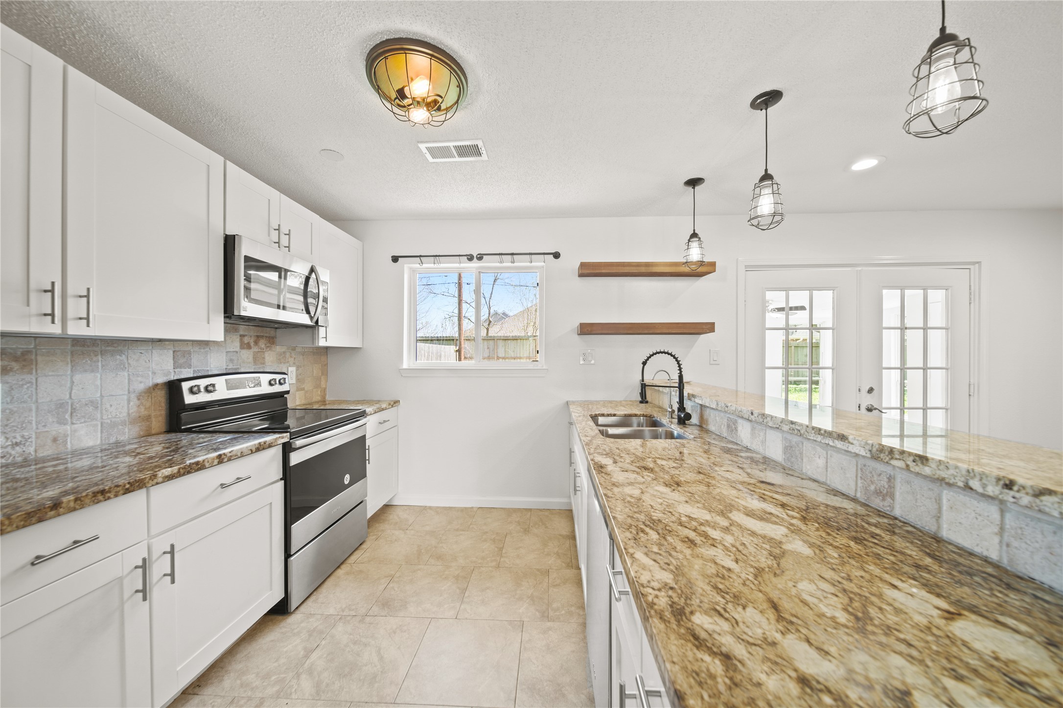 303 Rachael Lane Friendswood, TX 77546 - Photo 4 of 15 Beautiful kitchen with stainless steel appliances with refrigerator included.