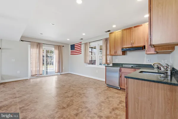 a kitchen with a sink a stove and cabinets