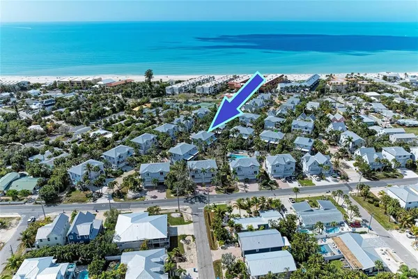 an aerial view of a houses with a lake view