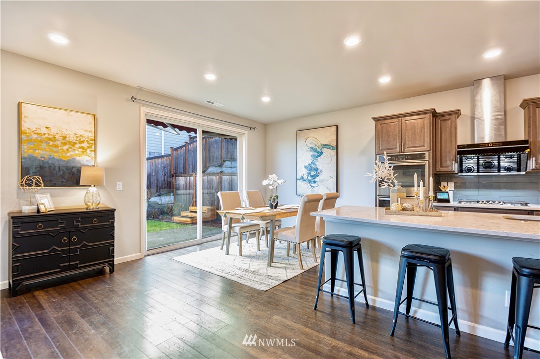 4411 236th Place Southeast Bothell, WA 98021 - Photo 11 of 31 a view of a dining room with furniture window and wooden floor