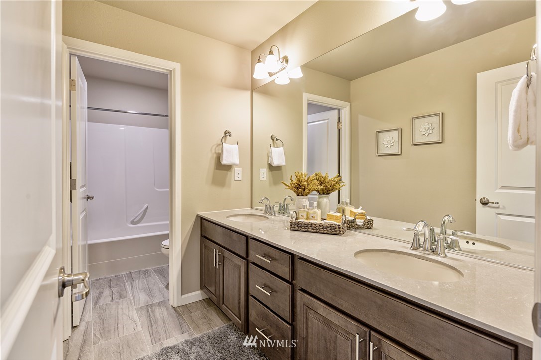 4411 236th Place Southeast Bothell, WA 98021 - Photo 16 of 31 a bathroom with a sink double vanity granite tub and a mirror