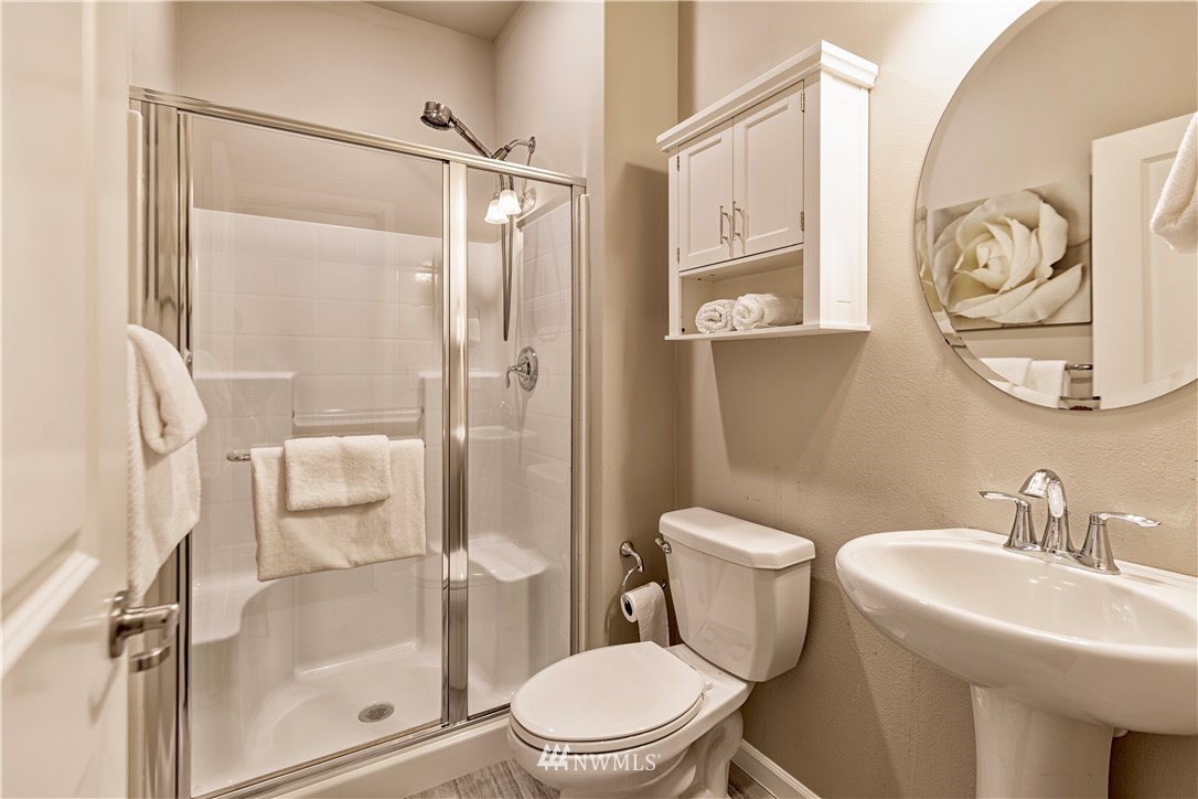 4411 236th Place Southeast Bothell, WA 98021 - Photo 23 of 31 a white toilet sitting next to a bathroom sink