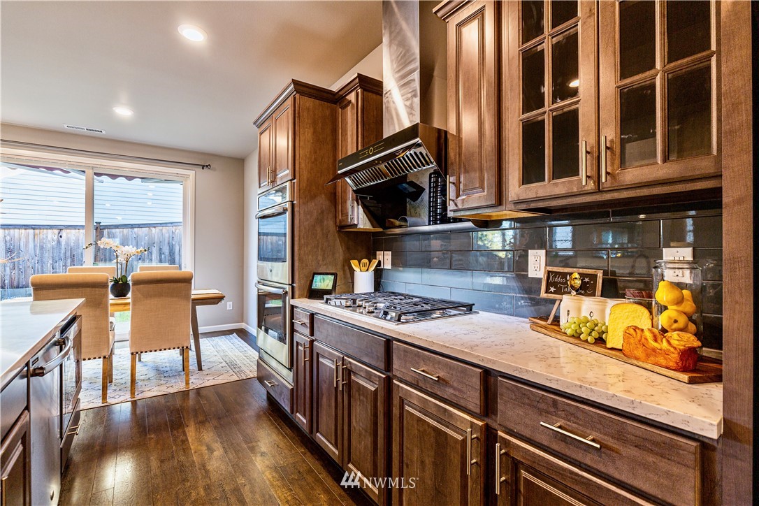 4411 236th Place Southeast Bothell, WA 98021 - Photo 5 of 31 a kitchen with stainless steel appliances granite countertop a stove and a wooden cabinets