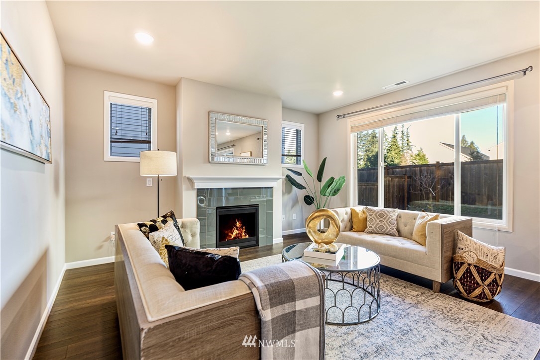 4411 236th Place Southeast Bothell, WA 98021 - Photo 10 of 31 a living room with furniture and a fireplace