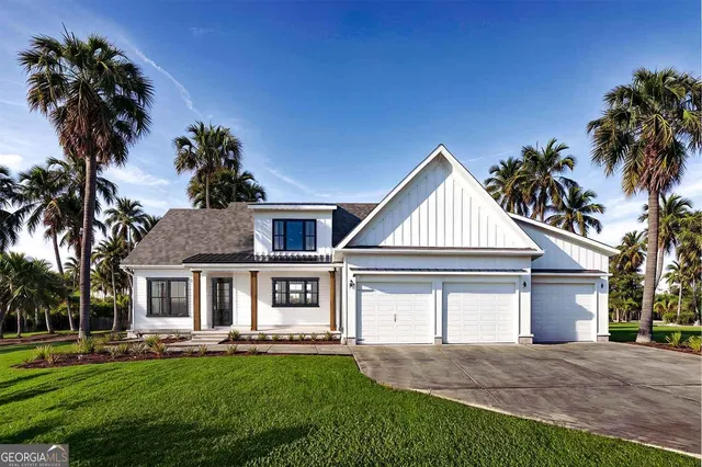 a front view of a house with a garden and yard
