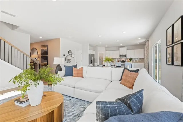 a living room with furniture and a chandelier