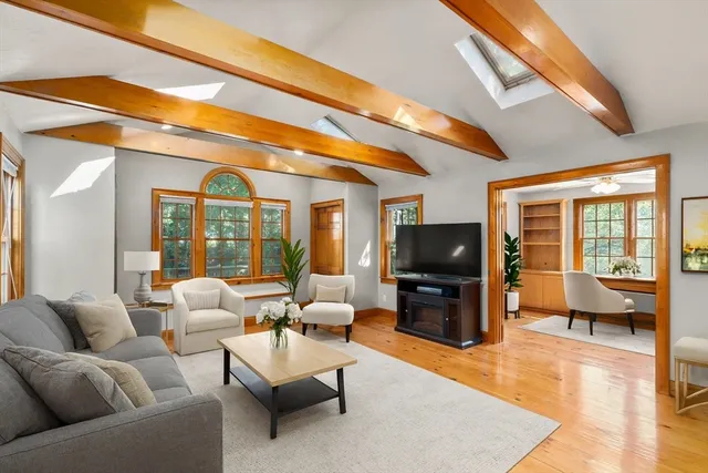 a living room with furniture and a flat screen tv
