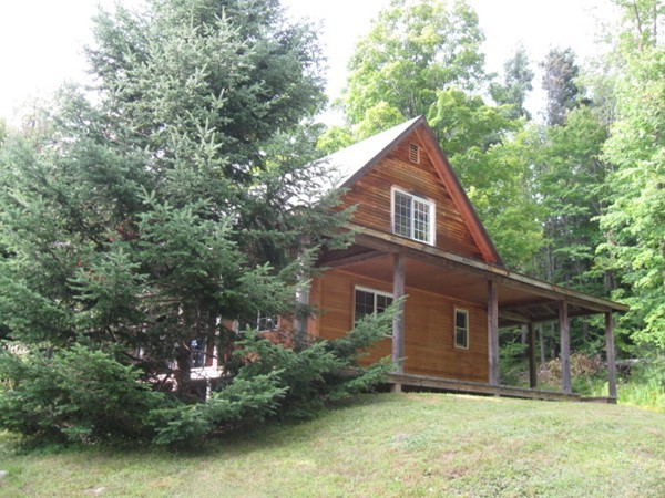 145 Leshure Road Rowe, MA 01367 - Photo 2 of 26 front view of a house with a yard