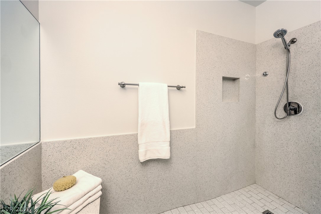 2050 West Warm Springs Road, Unit 1421 Henderson, NV 89014 - Photo 27 of 45 A well-appointed shower space features a built-in niche and sleek modern fixtures.