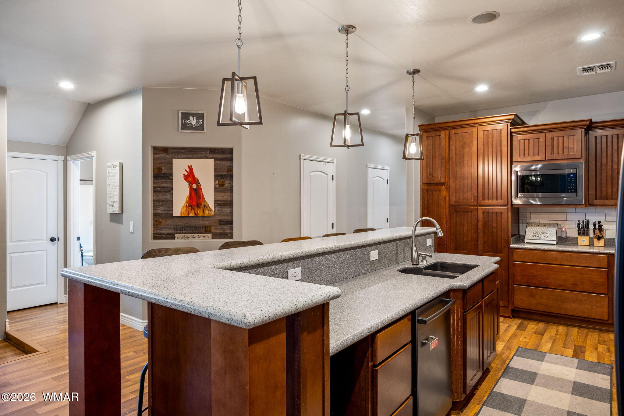 1940 Stonegate Way Heber, AZ 85928 - Photo 16 of 62 a kitchen with stainless steel appliances granite countertop a sink a stove and a wooden floor