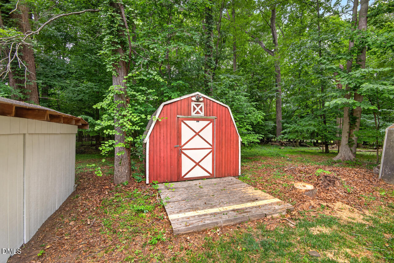 1420 Goodwin Road Durham, NC 27712 - Photo 44 of 54 a backyard of a house with large trees and plants