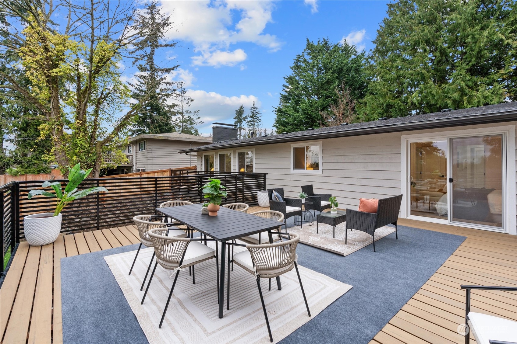 1256 Birch Street Edmonds, WA 98020 - Photo 22 of 37 a view of a roof deck with table and chairs and wooden floor