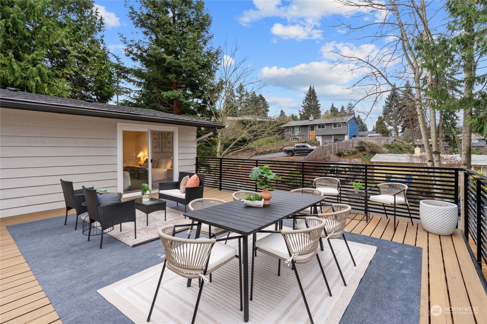 1256 Birch Street Edmonds, WA 98020 - Photo 23 of 37 a view of a roof deck with table and chairs and wooden floor
