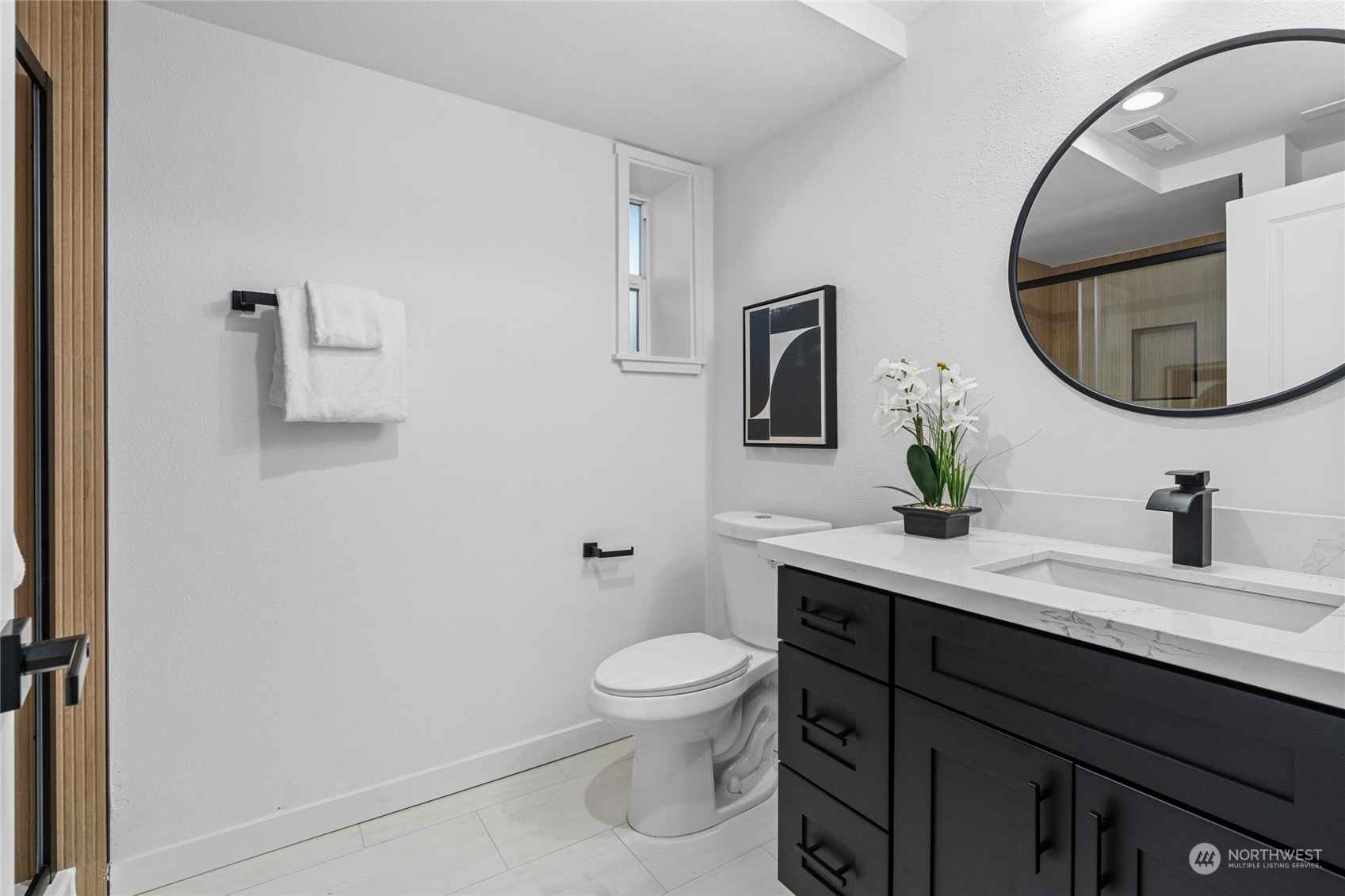 1256 Birch Street Edmonds, WA 98020 - Photo 30 of 37 a bathroom with a granite countertop toilet a sink and a mirror