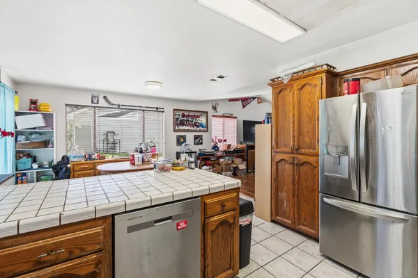 a kitchen with refrigerator and cabinets