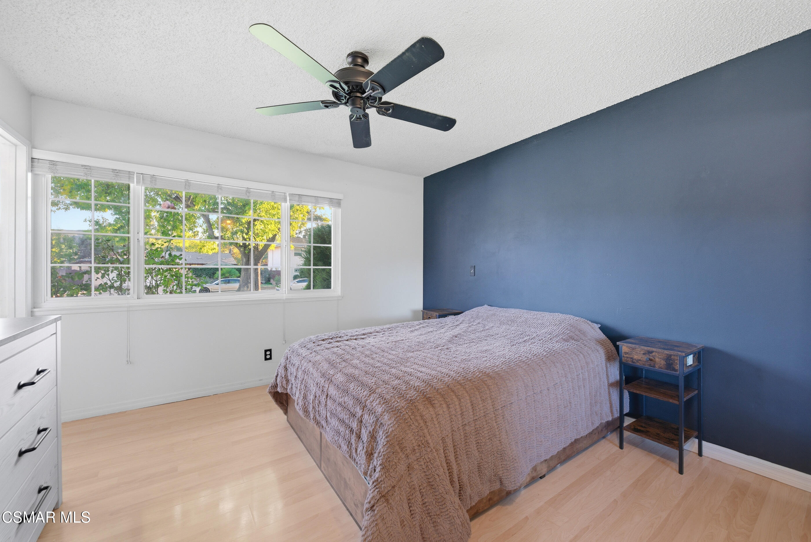 2267 Morley Street Simi Valley, CA 93065 - Photo 15 of 35 a bedroom with a bed a window and a chandelier