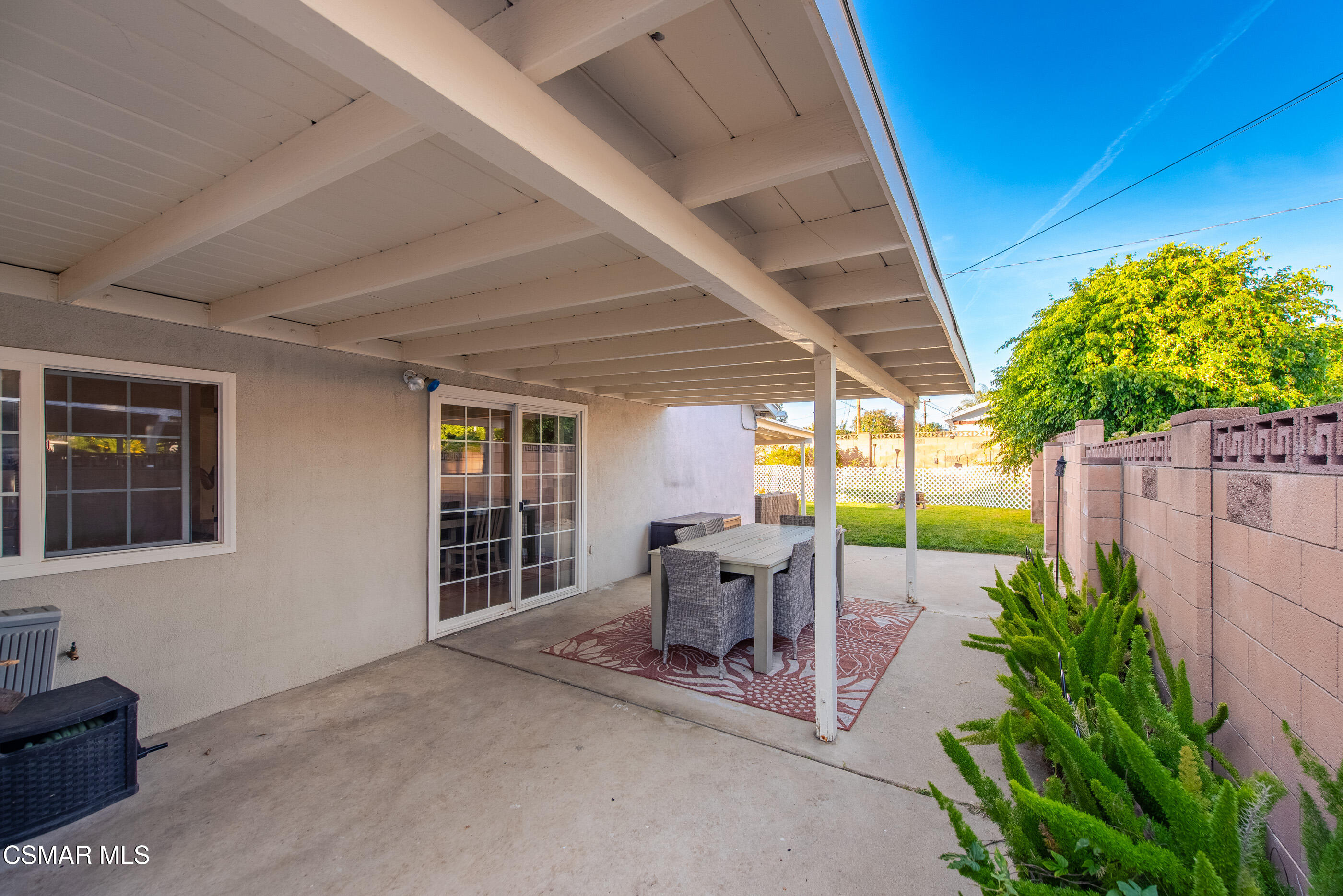 2267 Morley Street Simi Valley, CA 93065 - Photo 31 of 35 a view of a patio with table and chairs potted plants and wooden fence