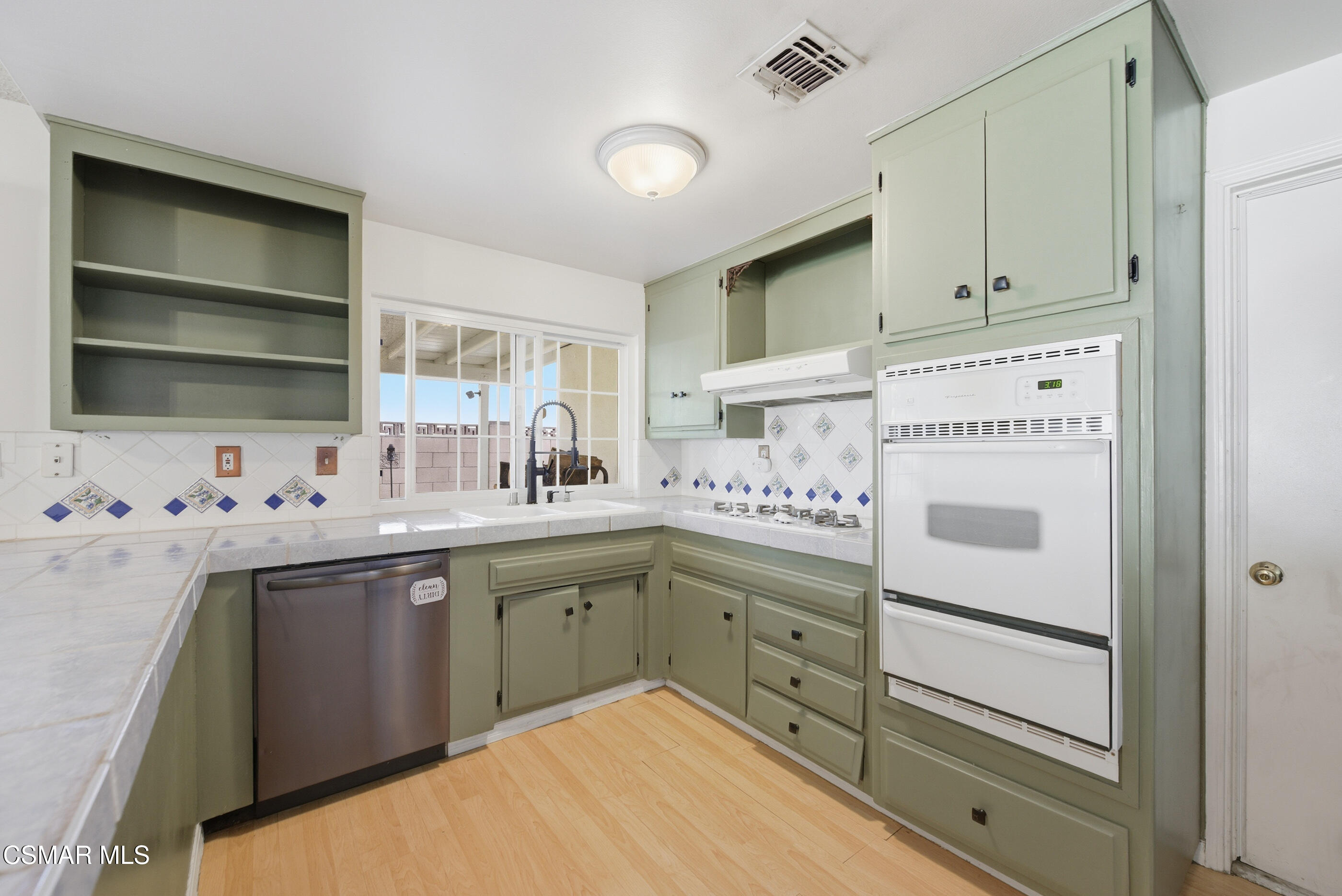 2267 Morley Street Simi Valley, CA 93065 - Photo 4 of 35 a kitchen with a sink cabinets and appliances