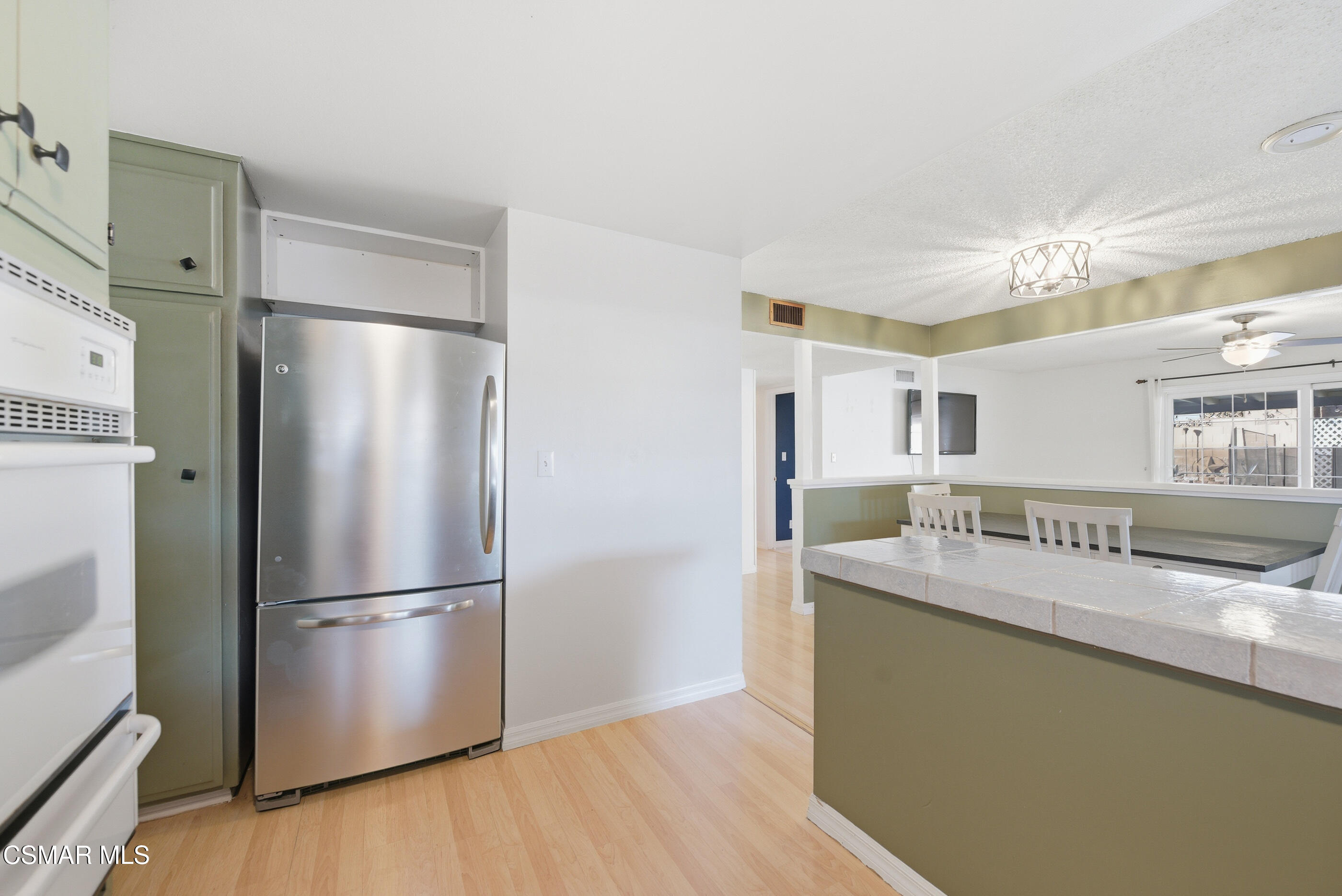 2267 Morley Street Simi Valley, CA 93065 - Photo 5 of 35 a kitchen with stainless steel appliances granite countertop a refrigerator a sink and a stove