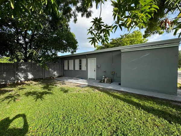 a view of a house with pool and sitting area