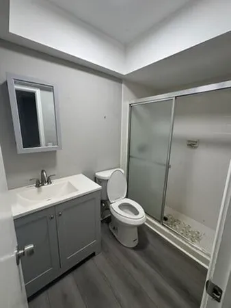 a bathroom with a toilet sink and shower