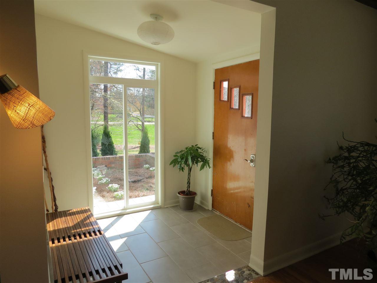 212 Bayleaf Drive Raleigh, NC 27615 - Photo 2 of 25 a living room with furniture and a floor to ceiling window