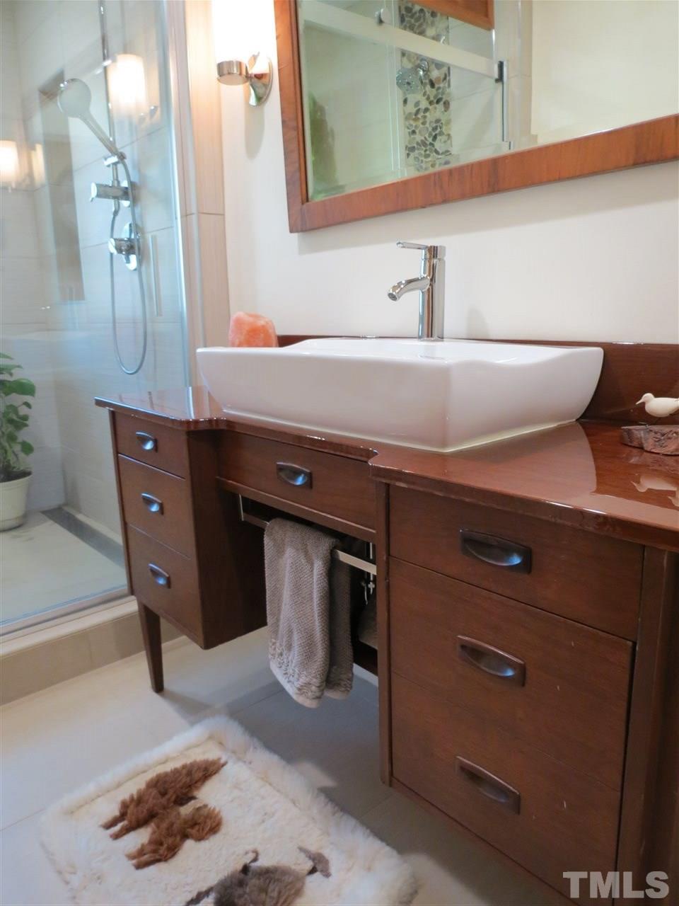 212 Bayleaf Drive Raleigh, NC 27615 - Photo 16 of 25 a bathroom with a sink and a mirror