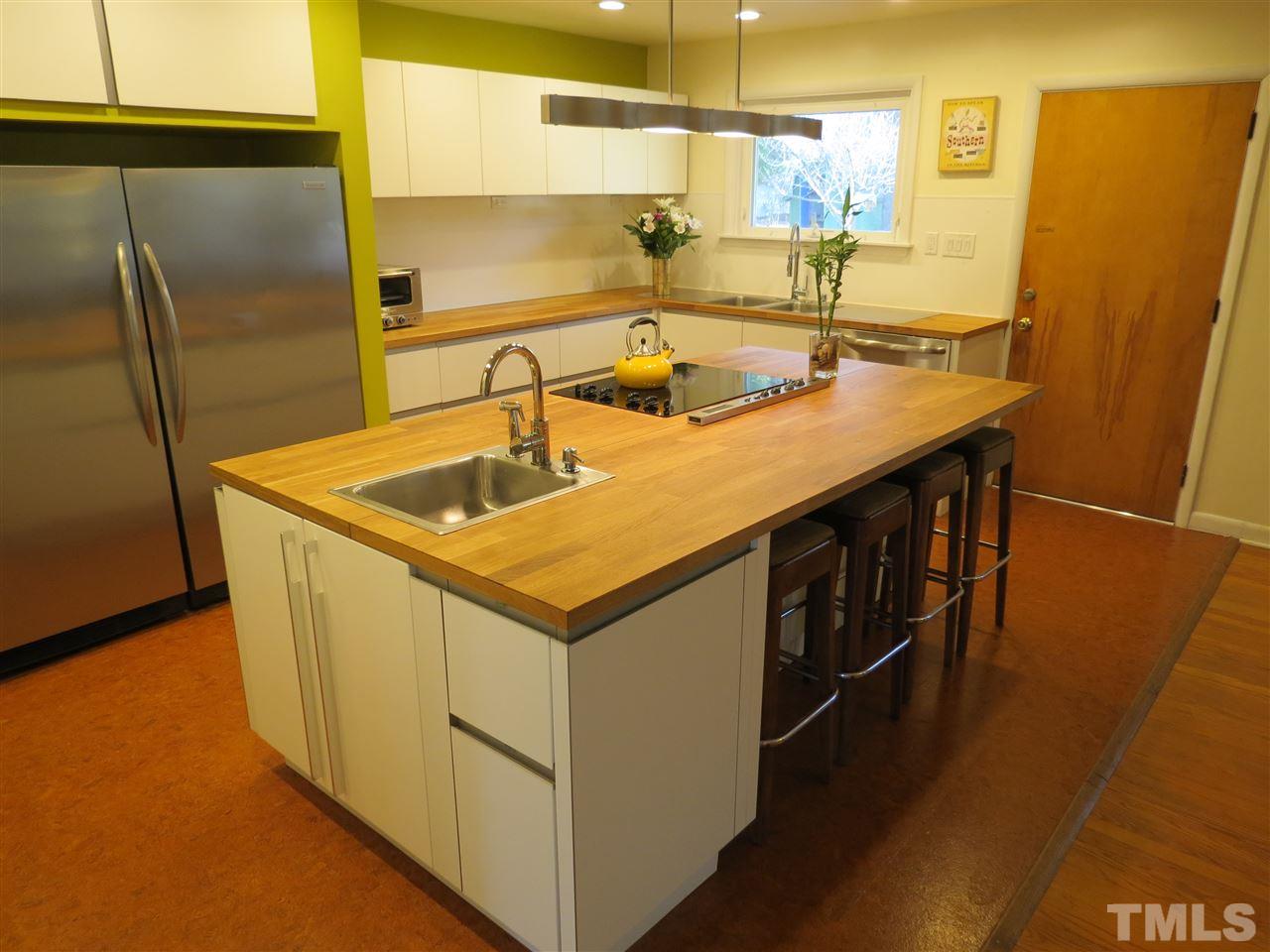 212 Bayleaf Drive Raleigh, NC 27615 - Photo 6 of 25 a kitchen with stainless steel appliances granite countertop a sink and a refrigerator