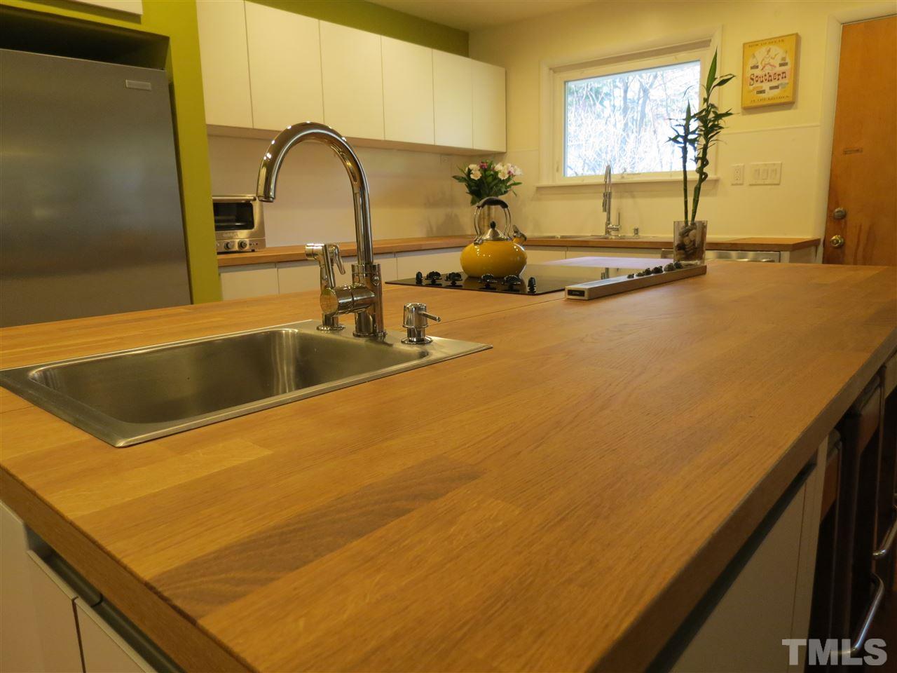 212 Bayleaf Drive Raleigh, NC 27615 - Photo 8 of 25 a kitchen with a sink and a large window