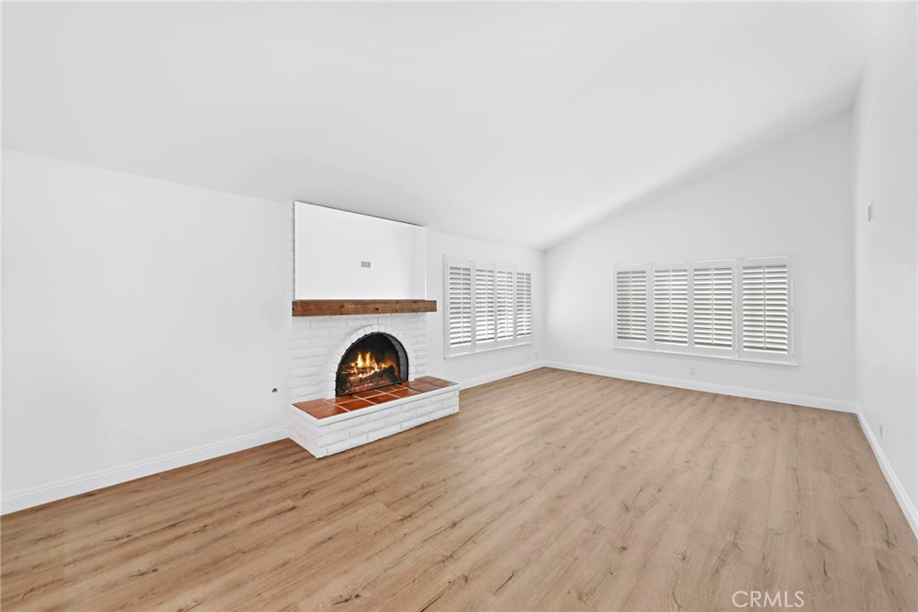 35491 Del Rey Dana Point, CA 92624 - Photo 4 of 48 an empty room with wooden floor fire place and windows