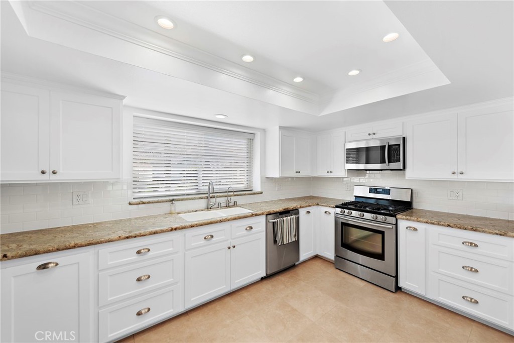 35491 Del Rey Dana Point, CA 92624 - Photo 9 of 48 a kitchen with granite countertop white cabinets and white appliances